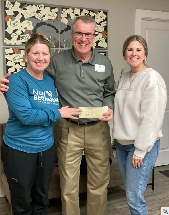 Bob Bowman presenting a $2,500 check to Jennifer Drake and Lindsey Moon at New Beginnings Pregnancy Resource Center 