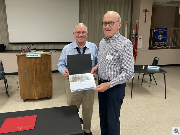 Grand Knight Rick Phillips presenting the Family of the Month Award to Bob Honzik