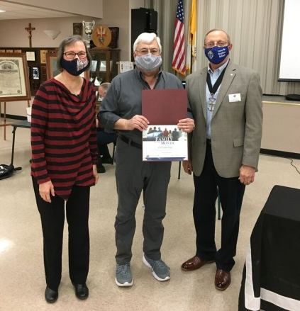 Rick and Sandy Darnell receiving the Family of the Month Award from Grand Knight Murray Claassen